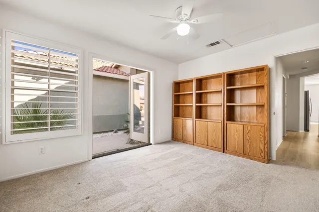 a view of an empty room with a ceiling fan
