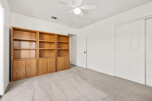 a bathroom with a granite countertop sink a toilet a mirror a bathtub and shower