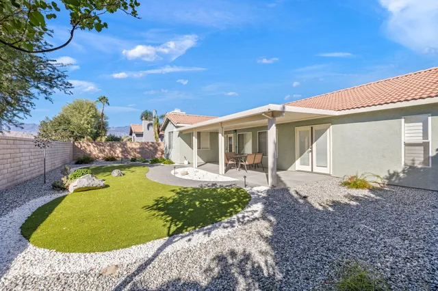 a view of a swimming pool with some potted plants