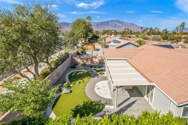 an aerial view of a house with yard swimming pool and outdoor seating