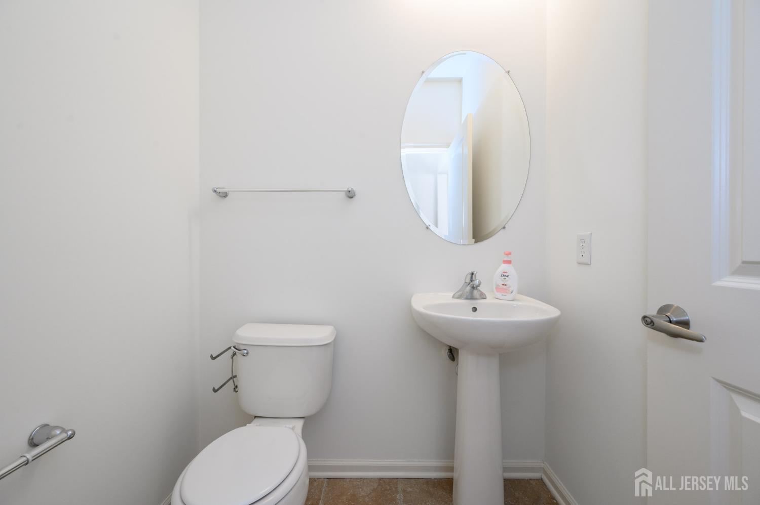 361 Lehigh Avenue Perth Amboy, NJ 08861 - Photo 12 of 28 a bathroom with a toilet a sink and mirror