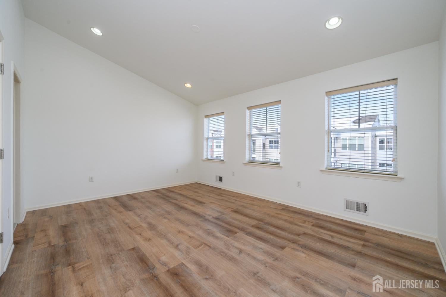 361 Lehigh Avenue Perth Amboy, NJ 08861 - Photo 14 of 28 a view of empty room with wooden floor and fan