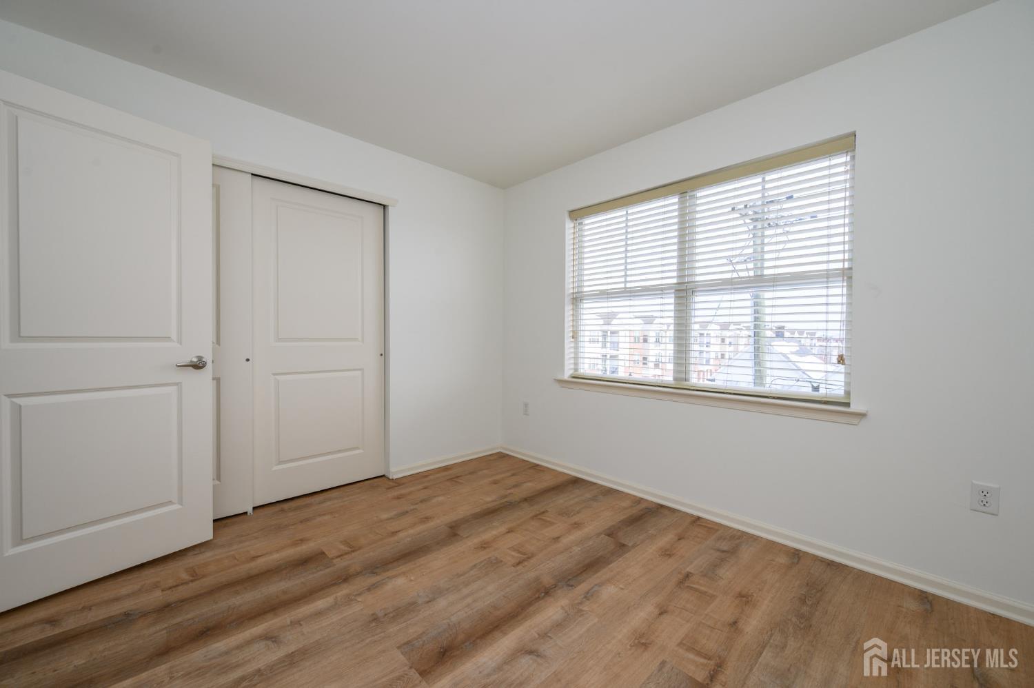 361 Lehigh Avenue Perth Amboy, NJ 08861 - Photo 22 of 28 a view of empty room with wooden floor and fan