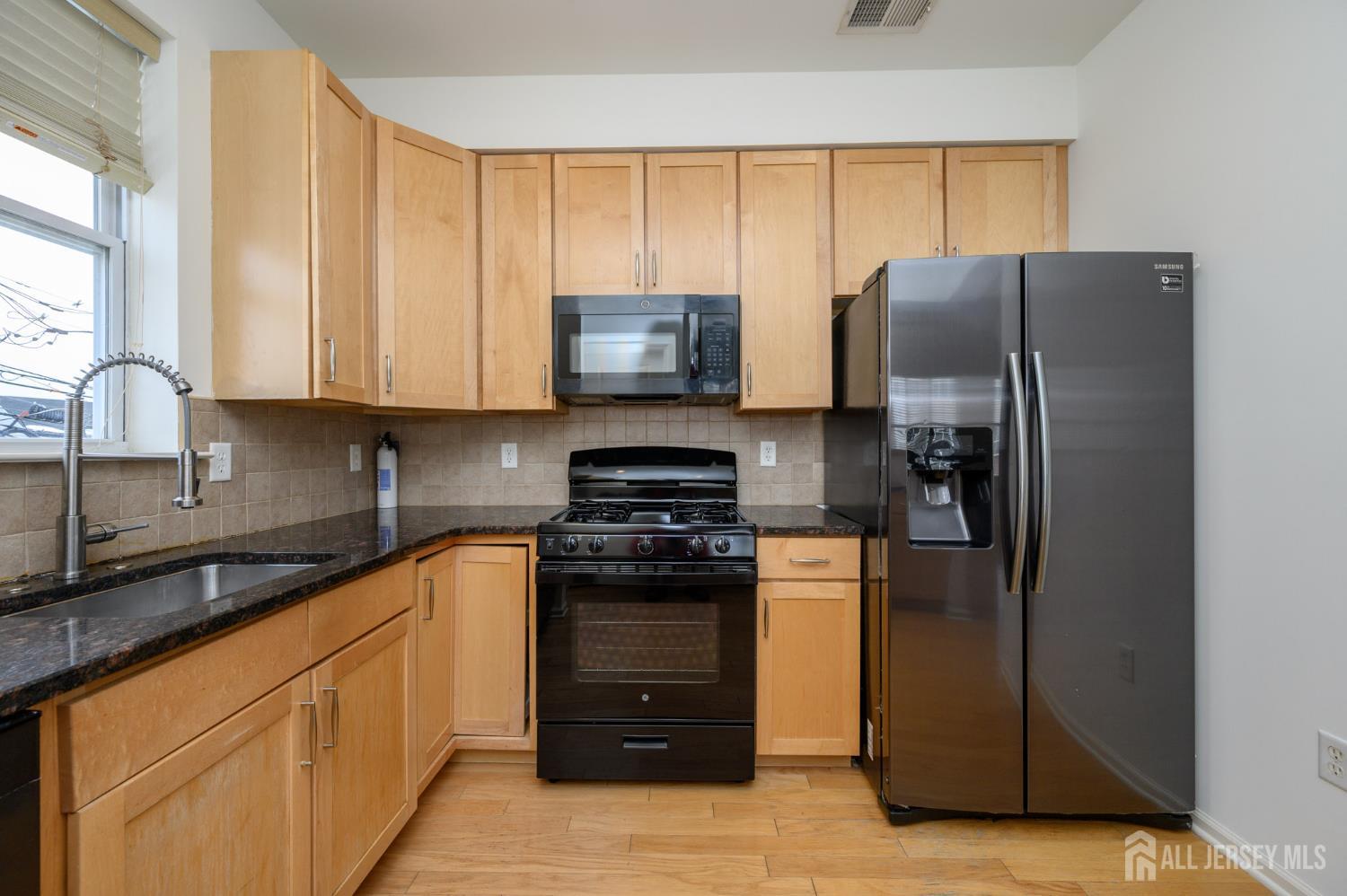 361 Lehigh Avenue Perth Amboy, NJ 08861 - Photo 10 of 28 a kitchen with a refrigerator and a sink