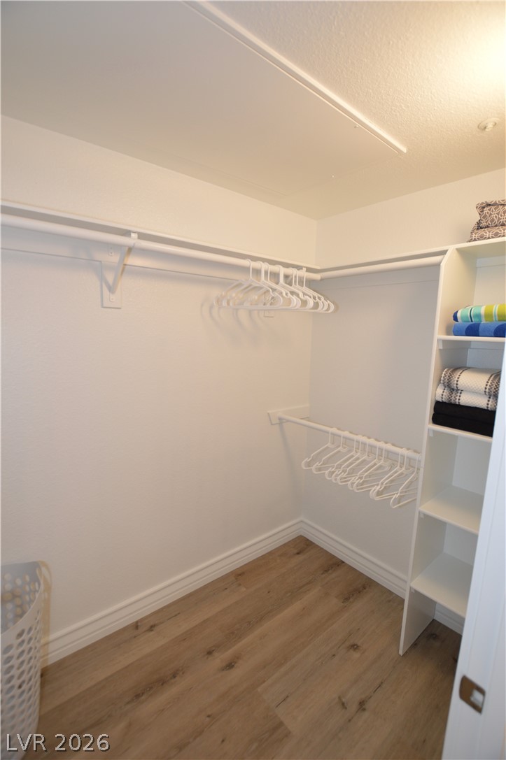 230 East Flamingo Road, Unit 334 Las Vegas, NV 89169 - Photo 10 of 37 An organized storage area features custom built-in shelving alongside durable wood-look flooring.