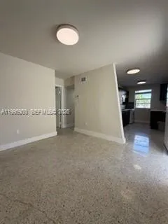 a view of a kitchen with a sink and a refrigerator