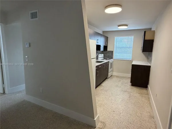 a kitchen with cabinets and stainless steel appliances