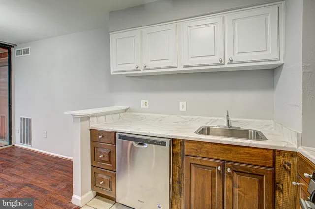 a kitchen with granite countertop a sink and cabinets