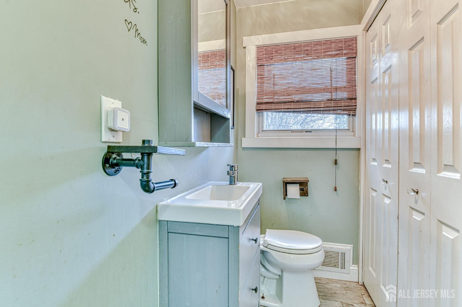 52 Owens Road Old Bridge, NJ 08857 - Photo 13 of 39 a bathroom with a toilet sink and mirror
