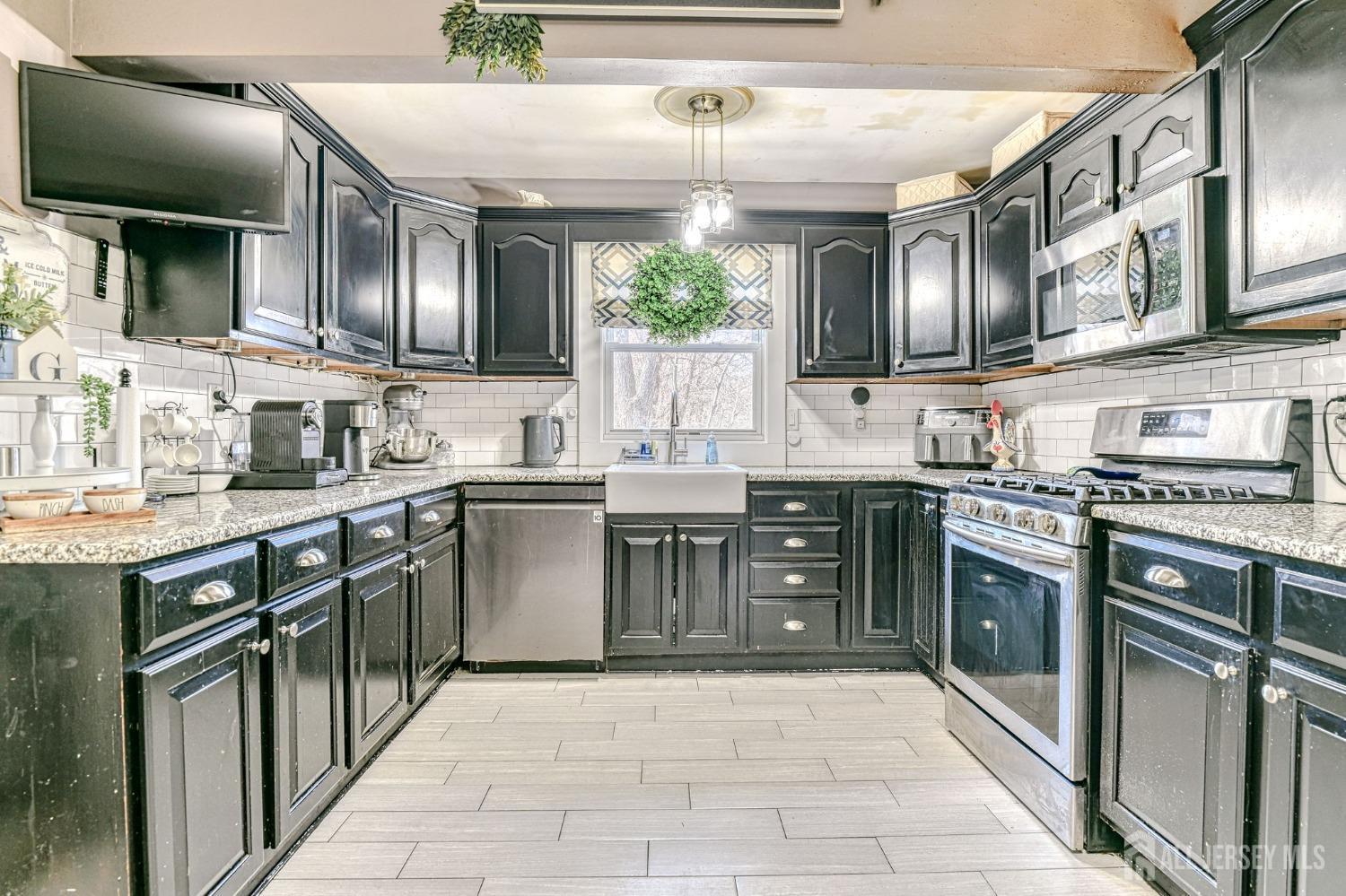 52 Owens Road Old Bridge, NJ 08857 - Photo 15 of 39 a kitchen with stainless steel appliances granite countertop a stove sink and cabinets
