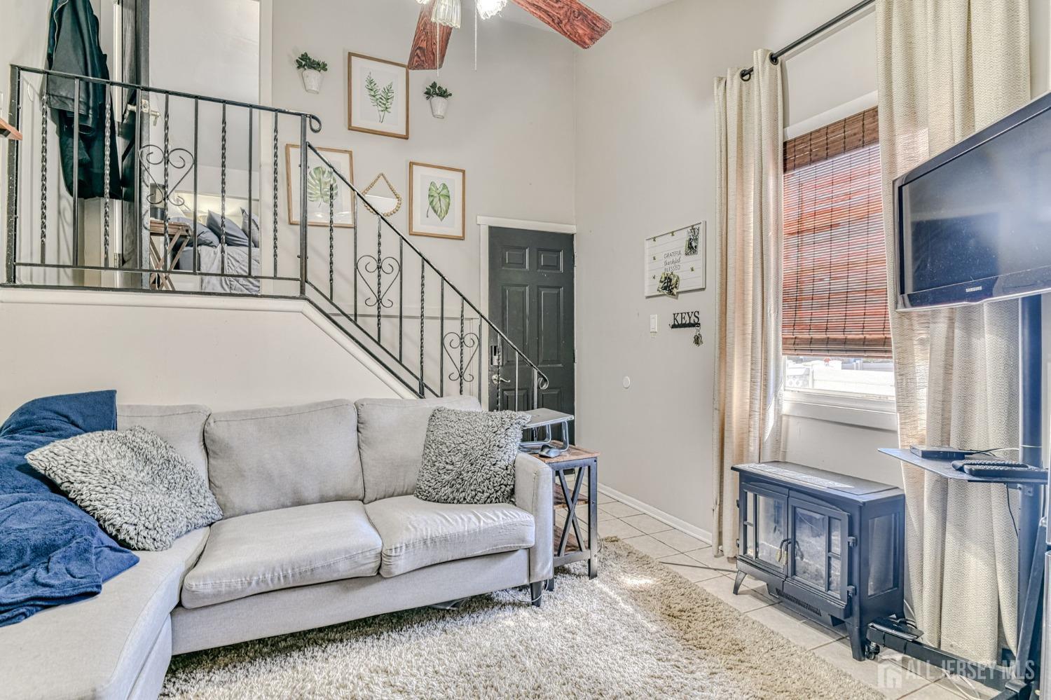 52 Owens Road Old Bridge, NJ 08857 - Photo 17 of 39 a living room with furniture flat screen tv and a refrigerator