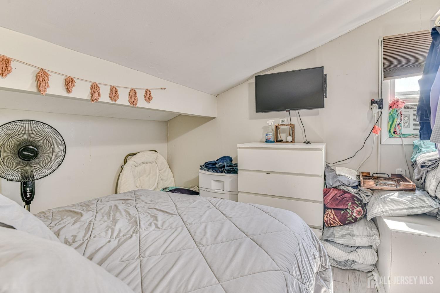 52 Owens Road Old Bridge, NJ 08857 - Photo 18 of 39 a bedroom with a bed and a flat screen tv