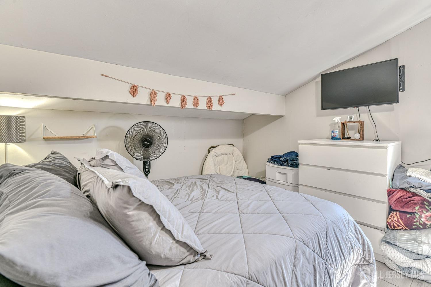 52 Owens Road Old Bridge, NJ 08857 - Photo 19 of 39 a bedroom with a bed and a flat screen tv