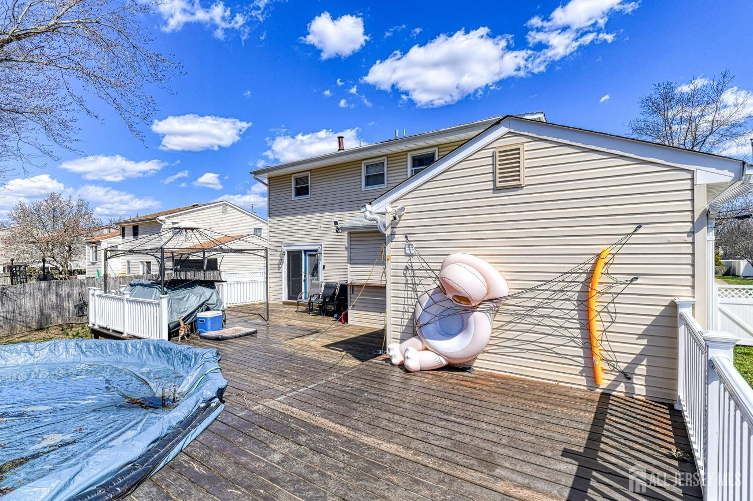52 Owens Road Old Bridge, NJ 08857 - Photo 33 of 39 a view of a patio with dining table and chairs with wooden floor