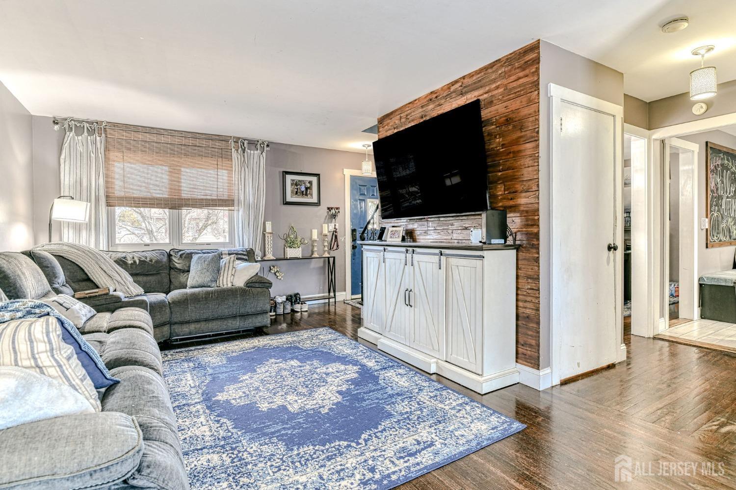 52 Owens Road Old Bridge, NJ 08857 - Photo 7 of 39 a living room with furniture and a flat screen tv