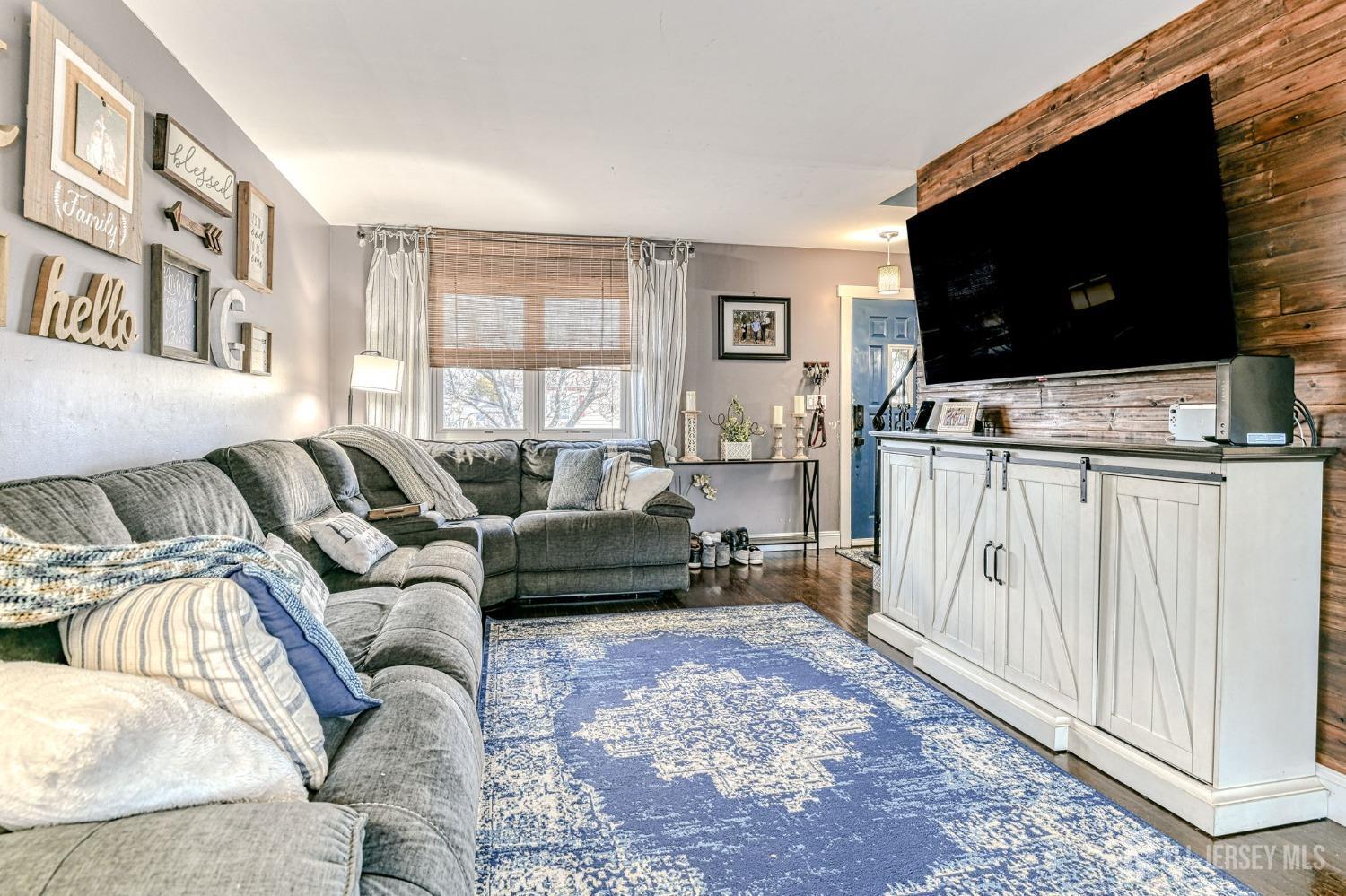 52 Owens Road Old Bridge, NJ 08857 - Photo 8 of 39 a living room with furniture and a flat screen tv
