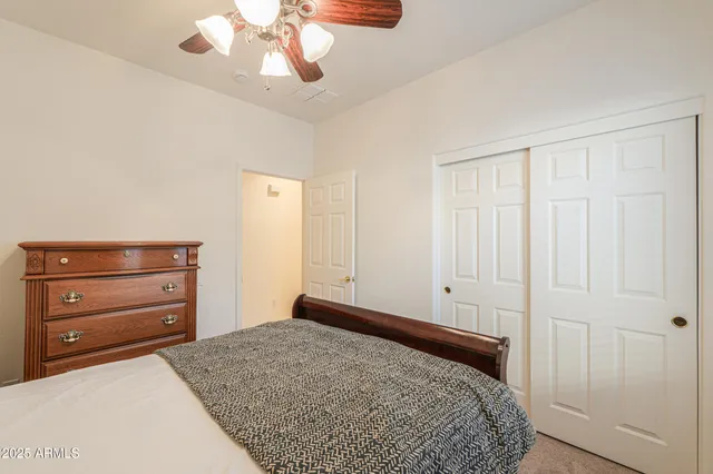 a bedroom with a bed and a dresser