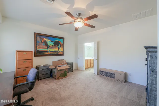 a living room with furniture and ceiling fan
