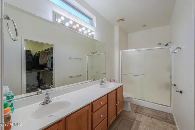 a spacious bathroom with a double vanity sink mirror and double