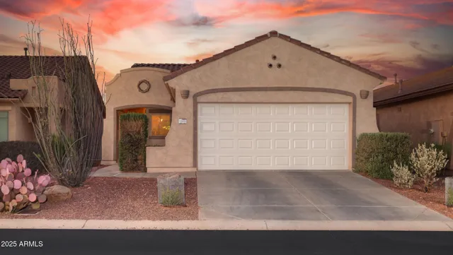 a view of a house with a yard and garage