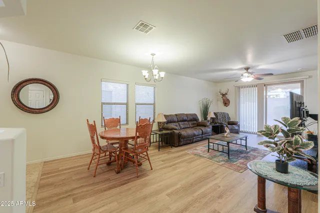 a view of a dining room with furniture and chandelier