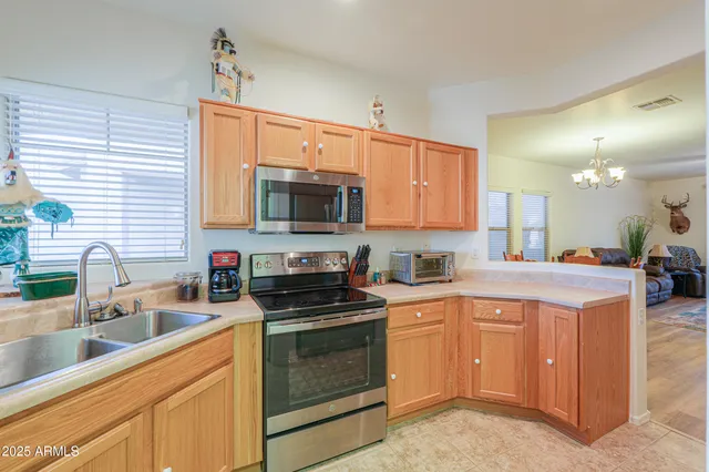 a kitchen with a sink a stove and cabinets