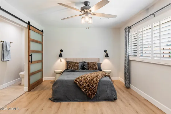 a bedroom with furniture and a mirror