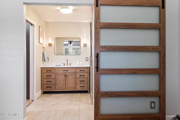 a bathroom with a double vanity sink mirror and shower