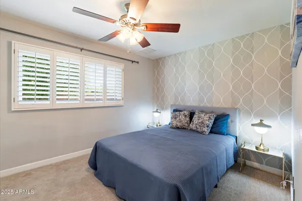 a walk in closet with wooden floor