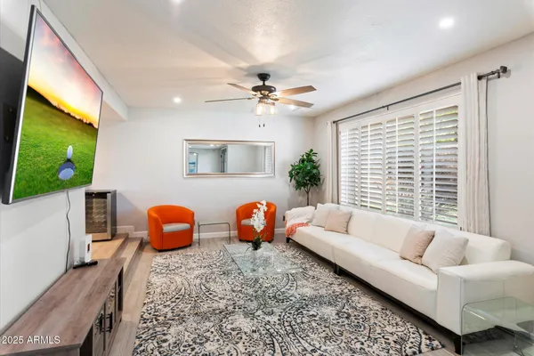 a living room with furniture a fireplace and a flat screen tv