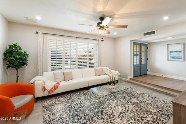 a living room with furniture and a large window