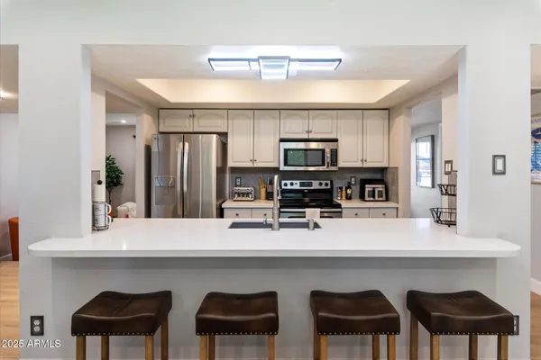 a kitchen with appliances cabinets and furniture