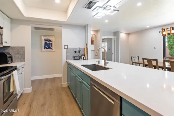 a kitchen with a sink a stove and cabinets