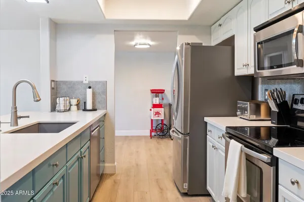 a kitchen with stainless steel appliances granite countertop a stove microwave and refrigerator