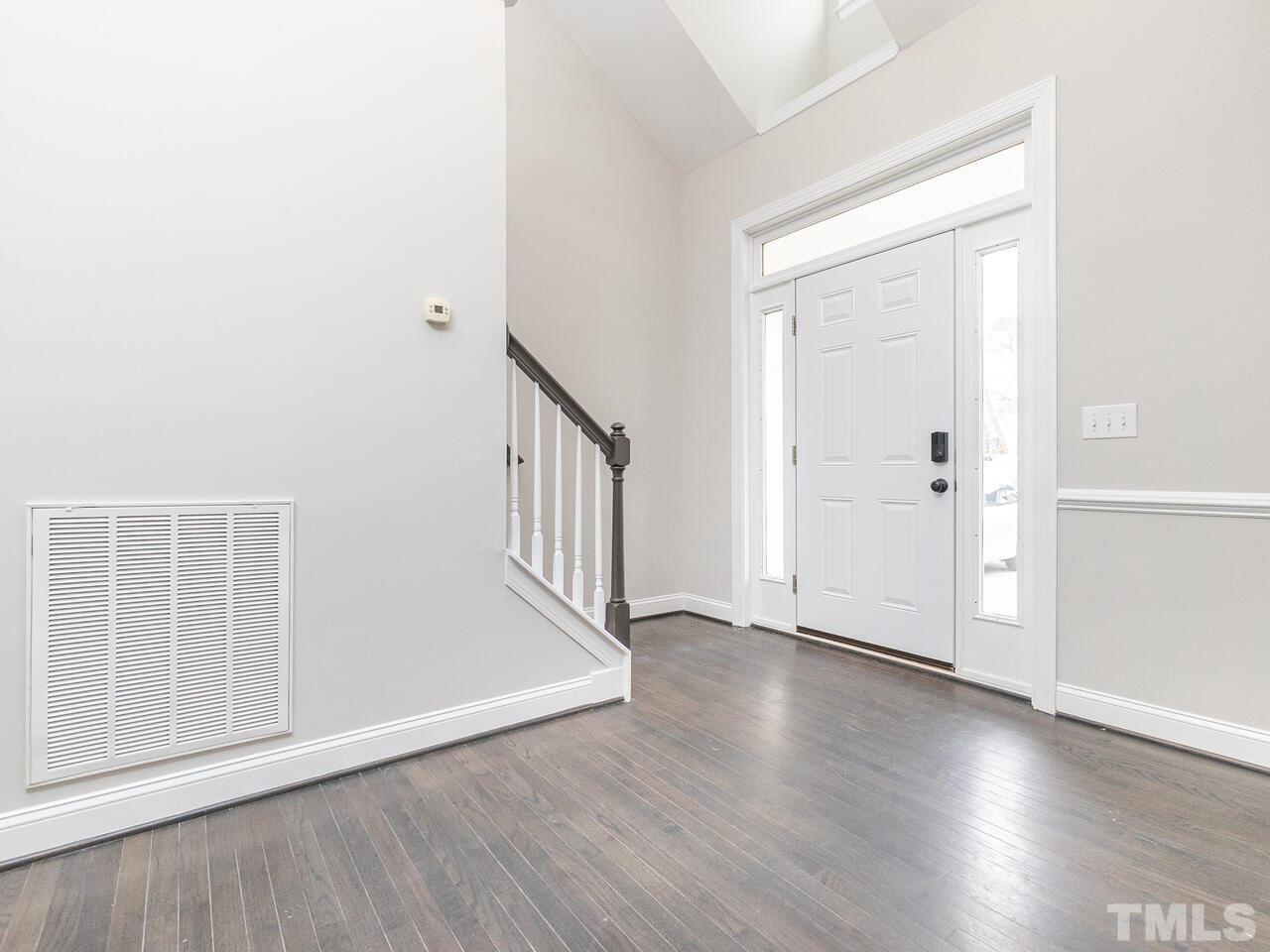 7916 Milltrace Run Raleigh, NC 27615 - Photo 3 of 28 an empty room with wooden floor and windows