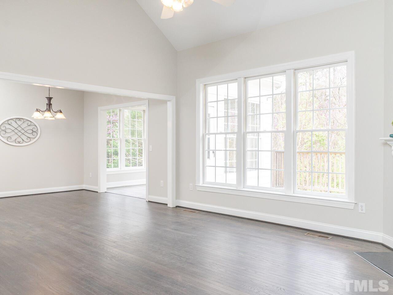 7916 Milltrace Run Raleigh, NC 27615 - Photo 8 of 28 an empty room with wooden floor and windows