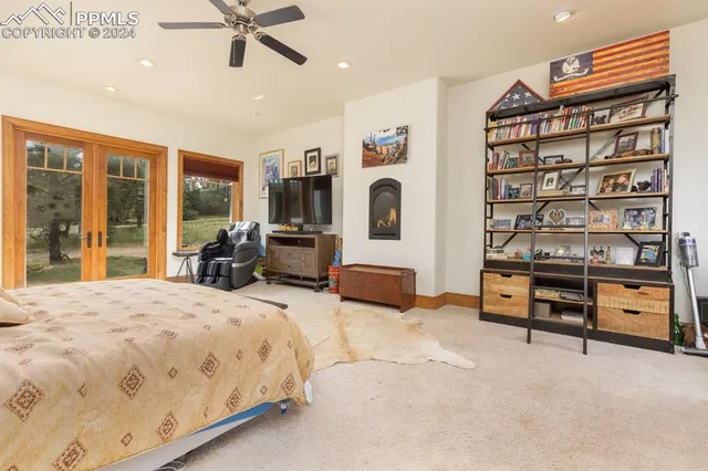 a bedroom with furniture and a large window
