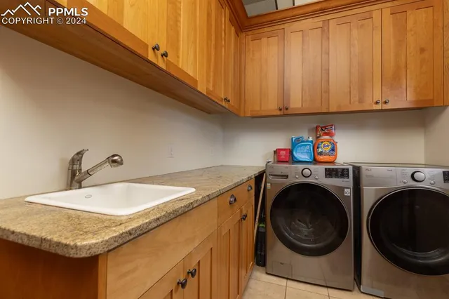 a utility room with sink dryer and washer