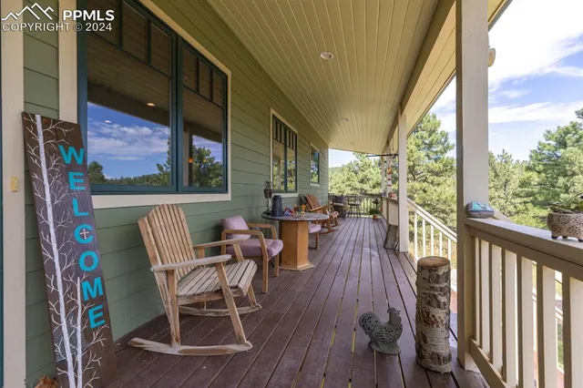 a view of balcony with chairs and wooden floor