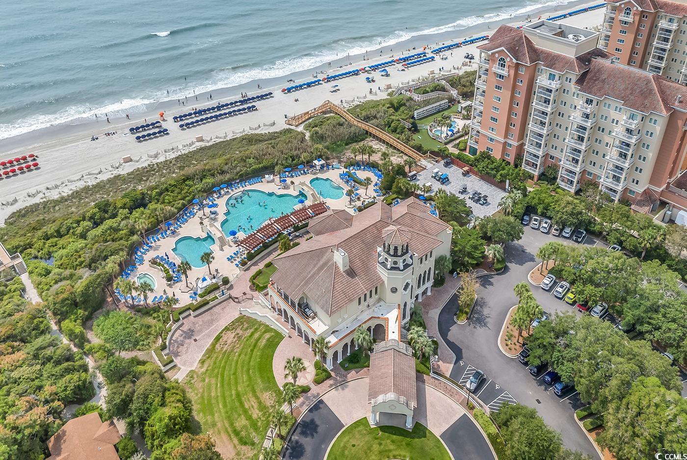 8488 Cape Dutch Loop Myrtle Beach, SC 29572 - Photo 22 of 29 Drone / aerial view of a pool area and expansive beach