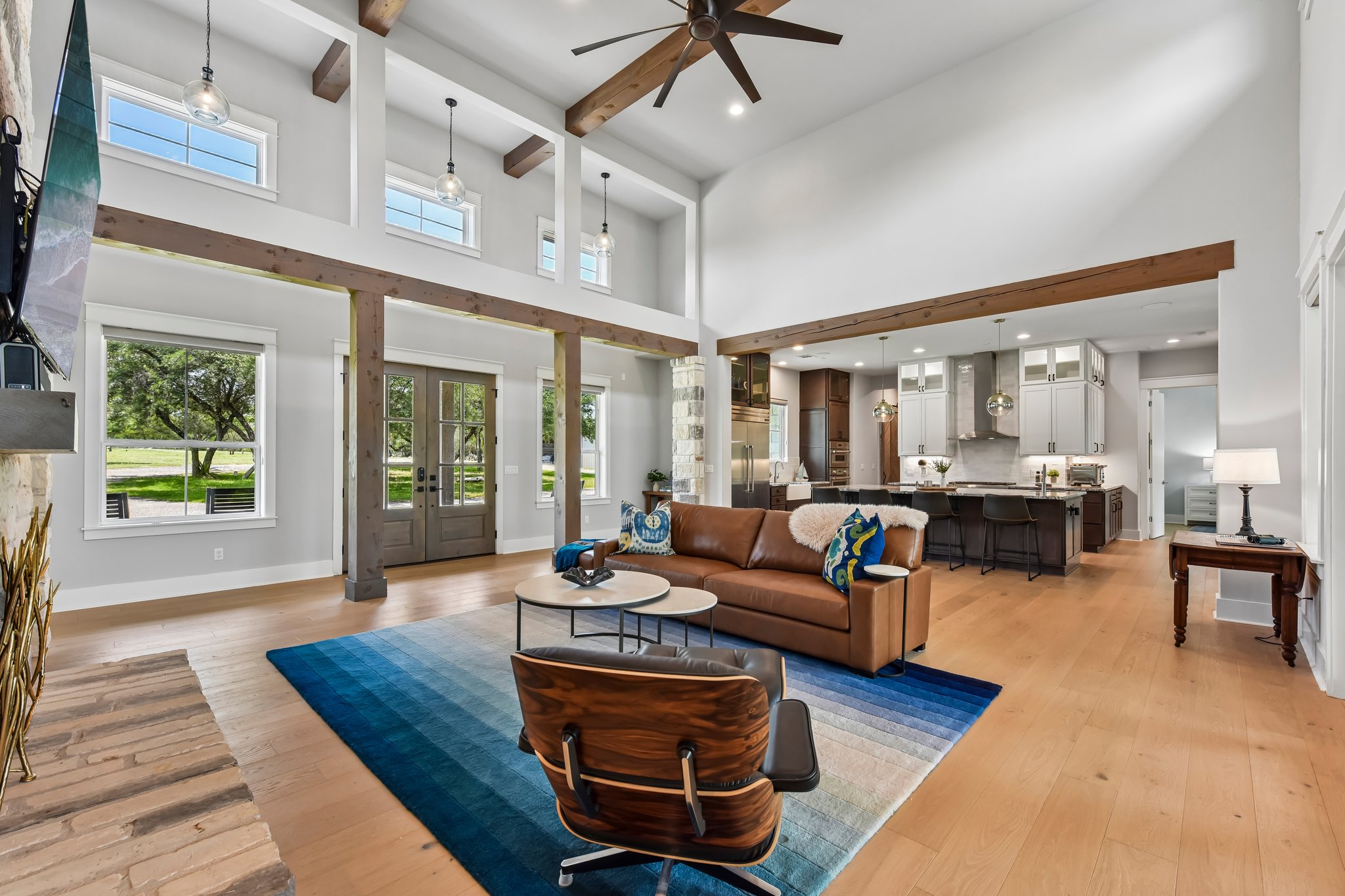 2203 Improver Road Spicewood, TX 78669 - Photo 3 of 38 Natural light floods this inviting living space, connecting seamlessly to a contemporary kitchen.