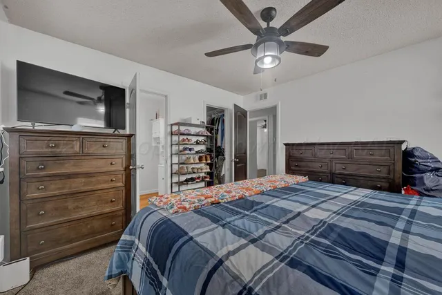 a bedroom with a bed and a television