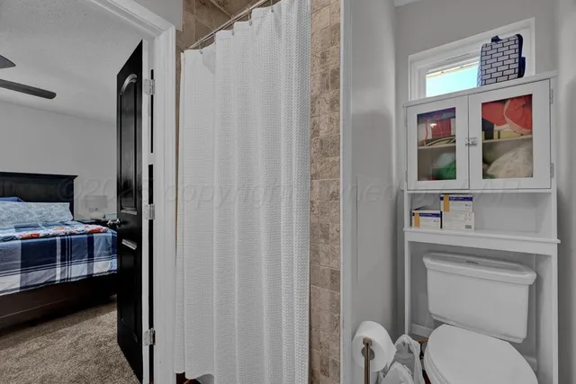 a en suite bathroom with a toilet sink and mirror