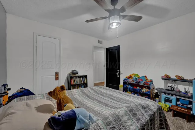 a bedroom with bed and a chandelier