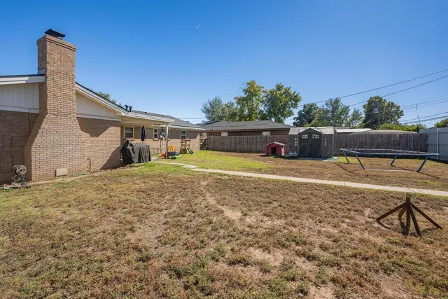 a view of a house with swimming pool and sitting area