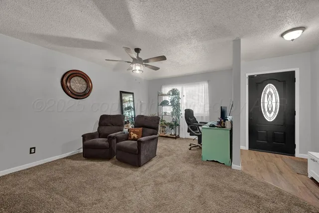 a view of a livingroom with furniture and a chandelier fan