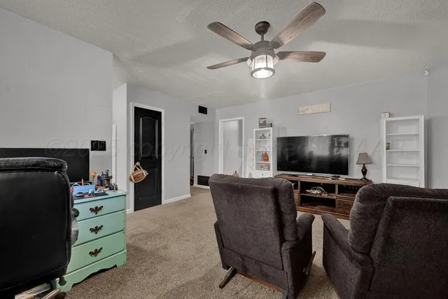 a view of a livingroom with furniture and a flat screen tv