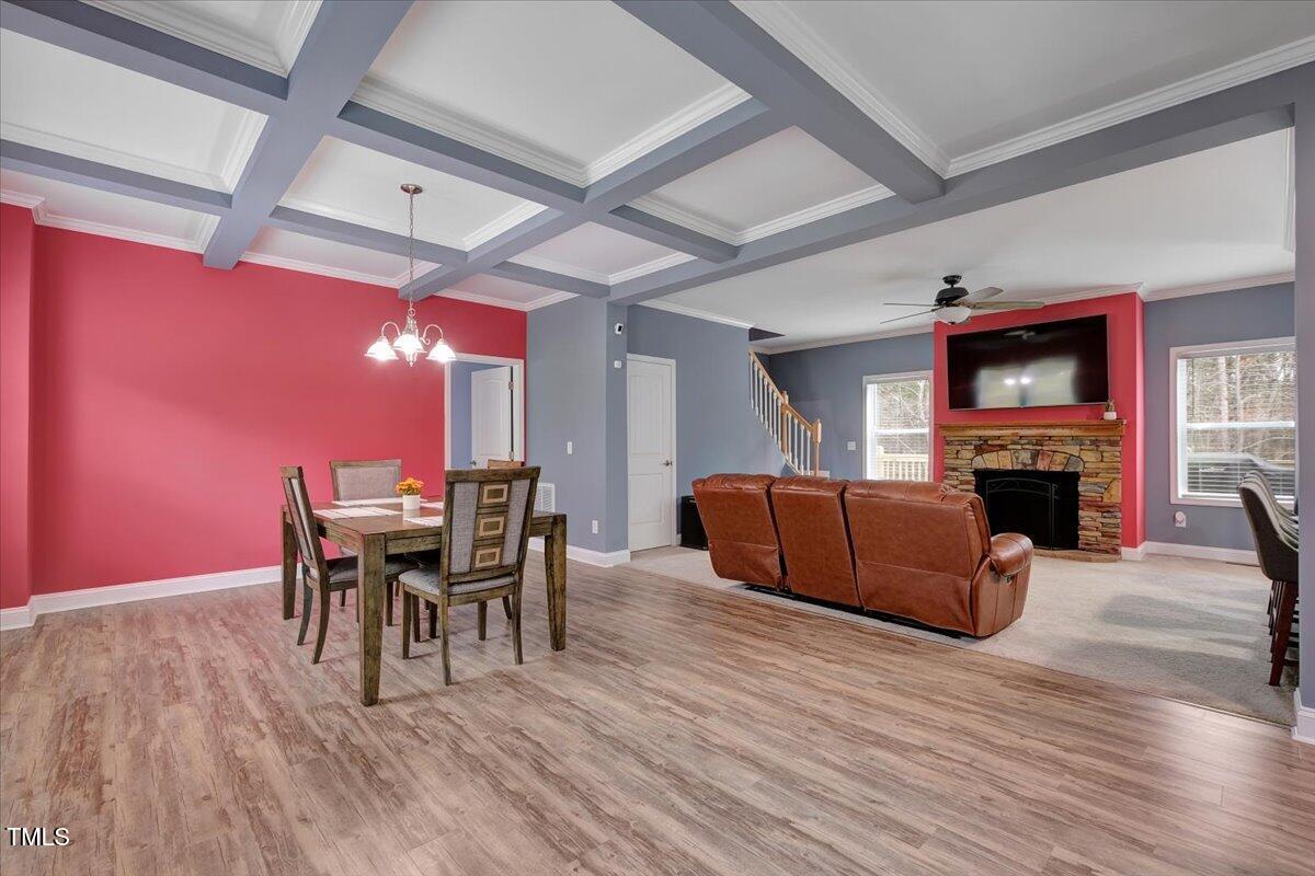 90 Ferncrest Court Roxboro, NC 27574 - Photo 11 of 45 a living room with furniture a fireplace and a dining table with wooden floor