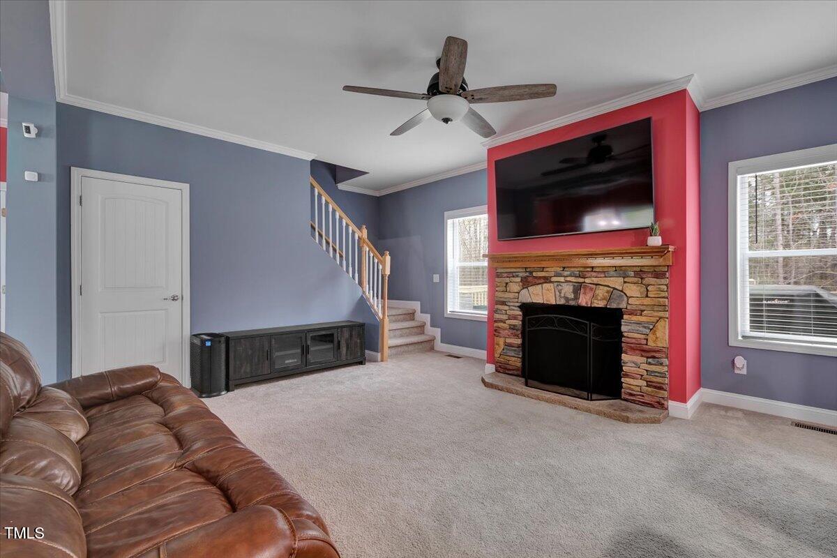 90 Ferncrest Court Roxboro, NC 27574 - Photo 14 of 45 a living room with furniture a flat screen tv and a fireplace