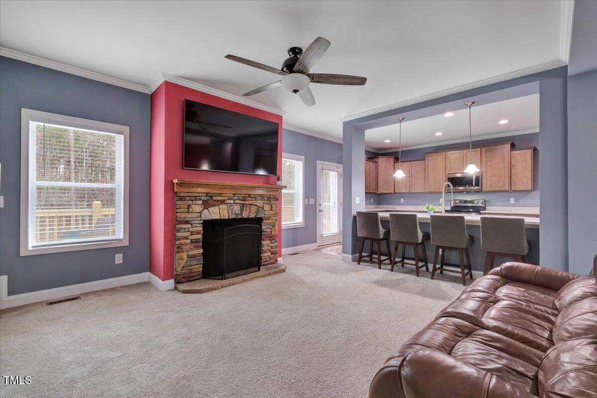 90 Ferncrest Court Roxboro, NC 27574 - Photo 15 of 45 a living room with furniture a fireplace and a kitchen